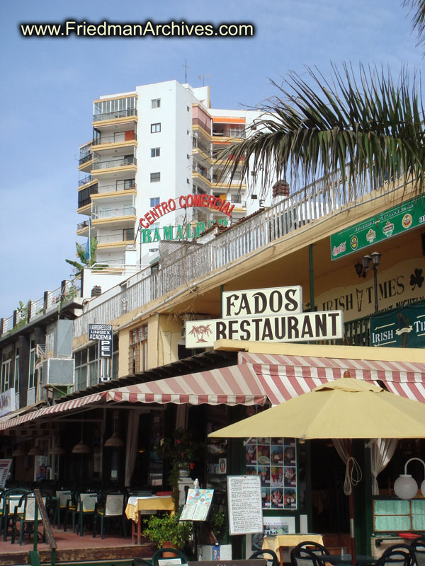 vacation,holiday,overcrowded,travel,relax,tourist,tourism,sun,buildings,Fados,Restaurant,signs,sidewalk,walkway,high-rise