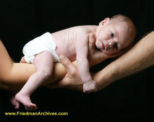 Newborn on arms